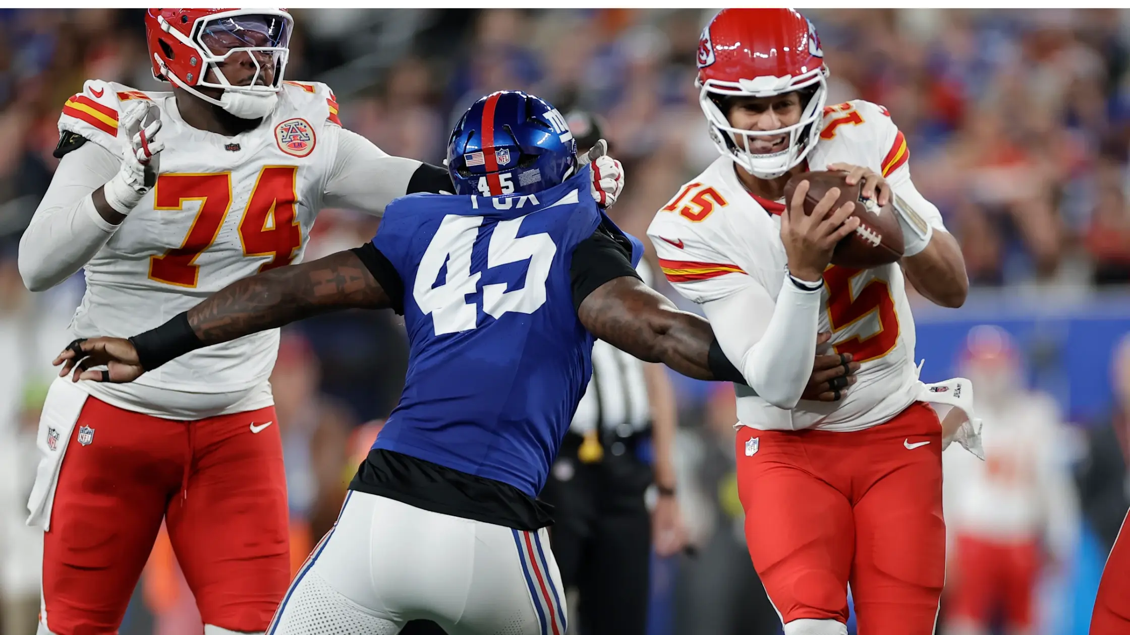 Patrick Mahomes, pictured dodging Giants outside linebacker Tomon Fox, grinded out a victory Sunday night for the Kansas City Chiefs' first victory of the season