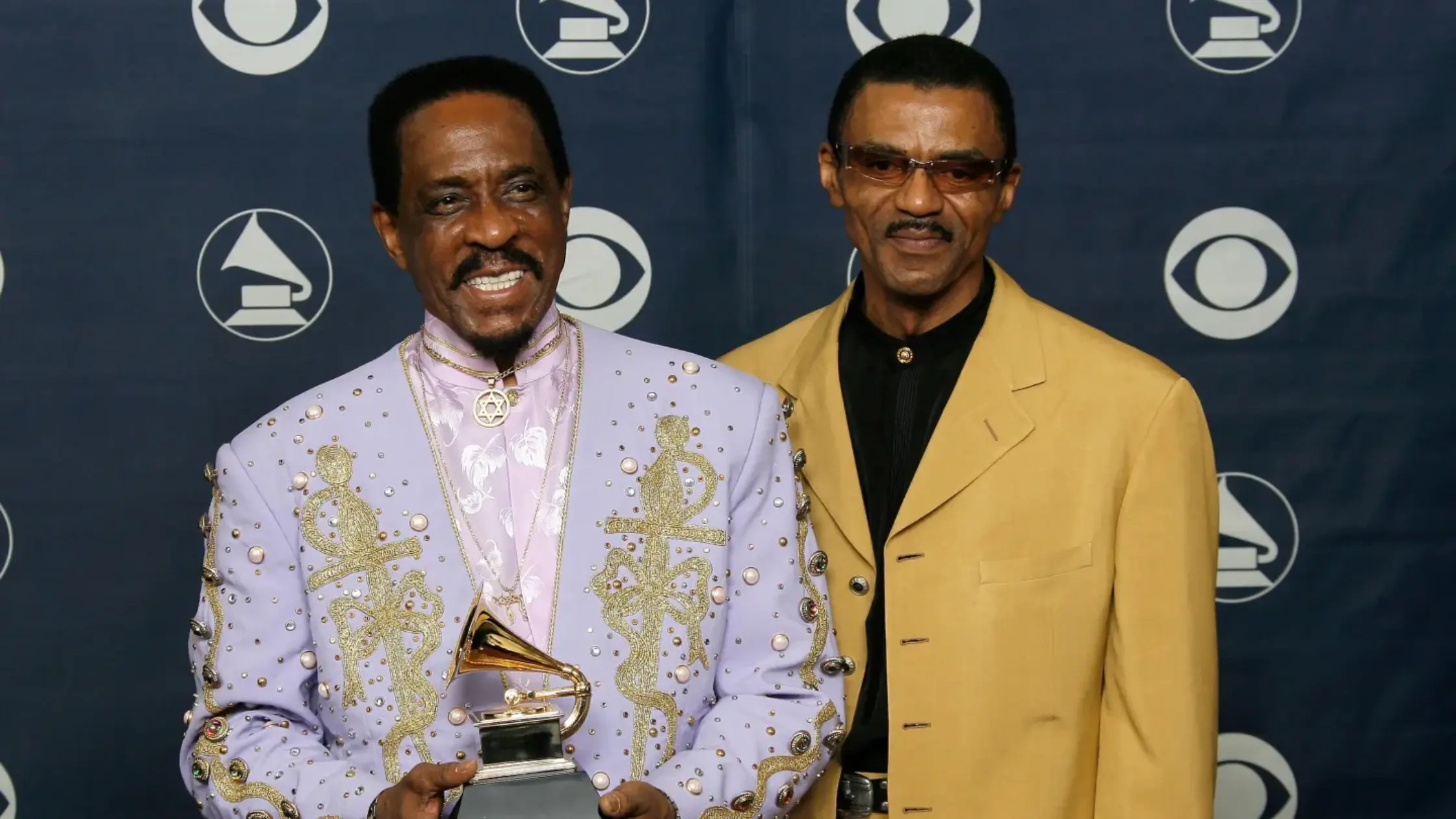 Ike Turner (left) and Ike Turner Jr. the Grammy for best traditional blues album for "Risin' With The Blues" in the press room at the 49th Annual Grammy Awards